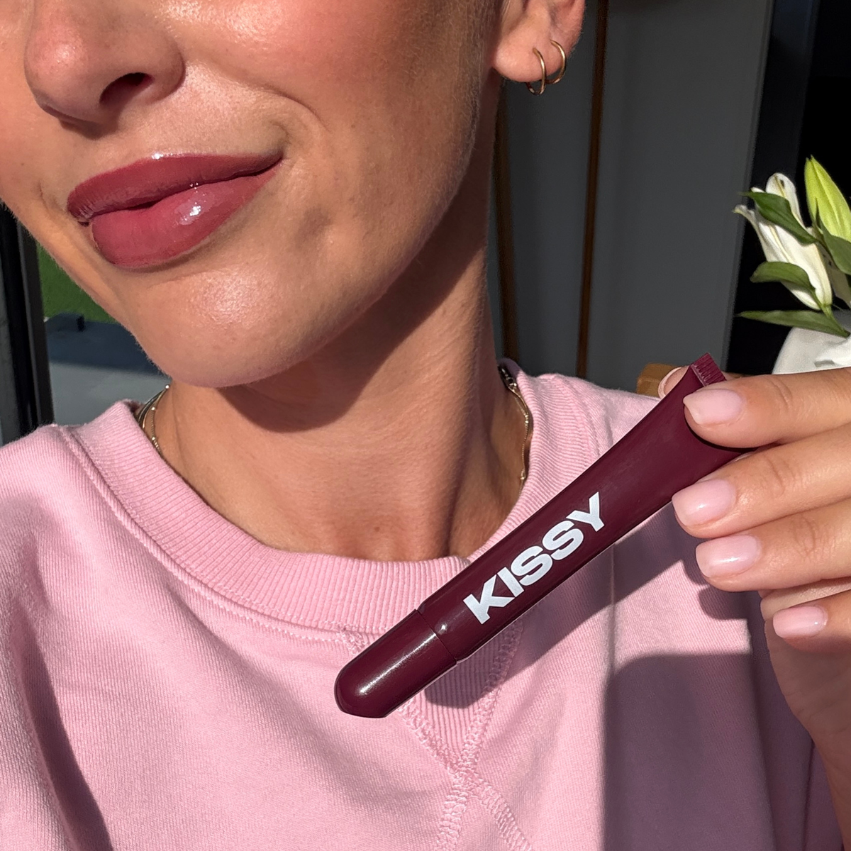 Open Kissy Gloss Berry tube showing the deep berry gloss applicator tip