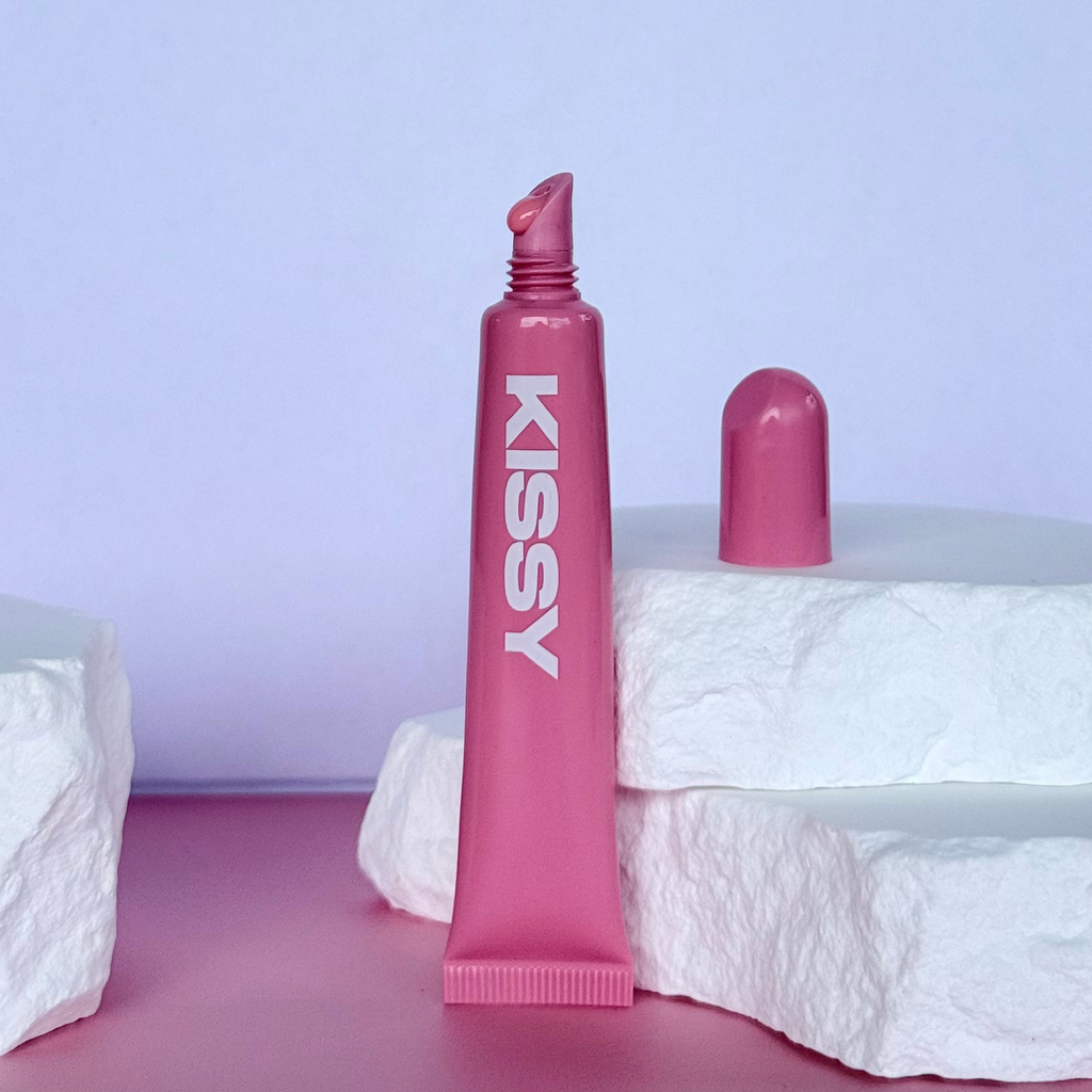 Open tube of Kissy Gloss Pink showing the pink lip gloss applicator