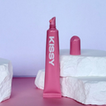 Open tube of Kissy Gloss Pink showing the pink lip gloss applicator